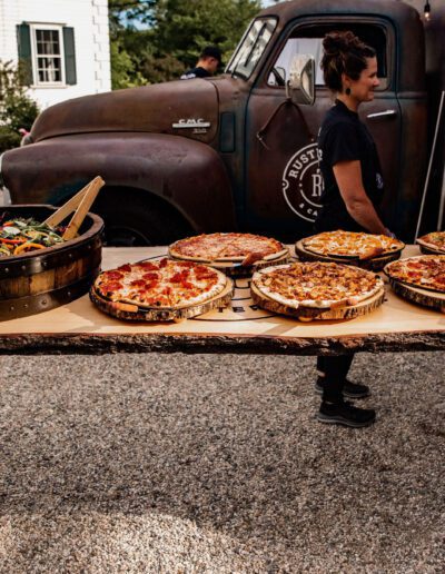 Pizza and tossed salad set up on bar infront of tap truck